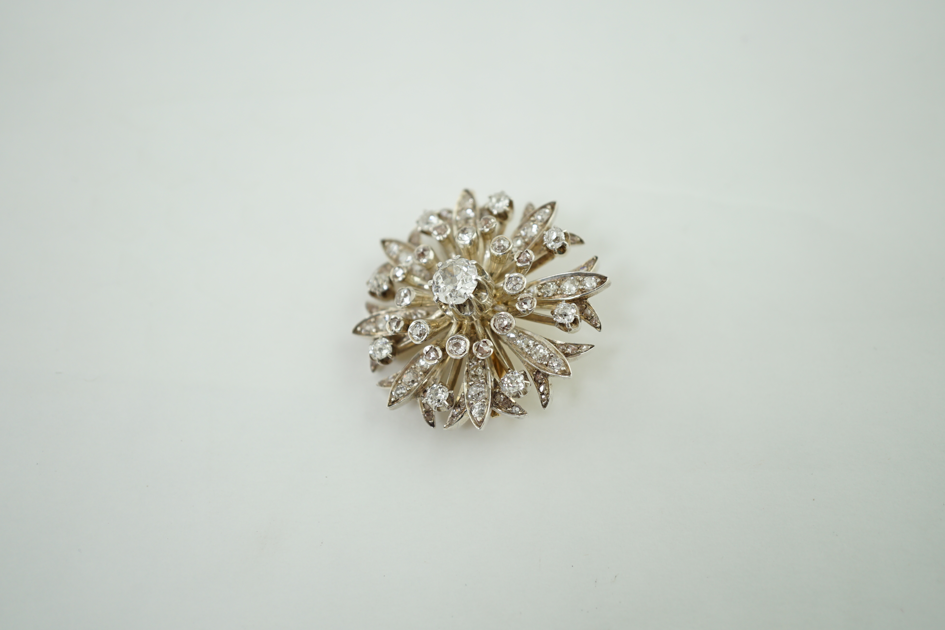 A late Victorian gold and diamond foliate starburst pendant brooch